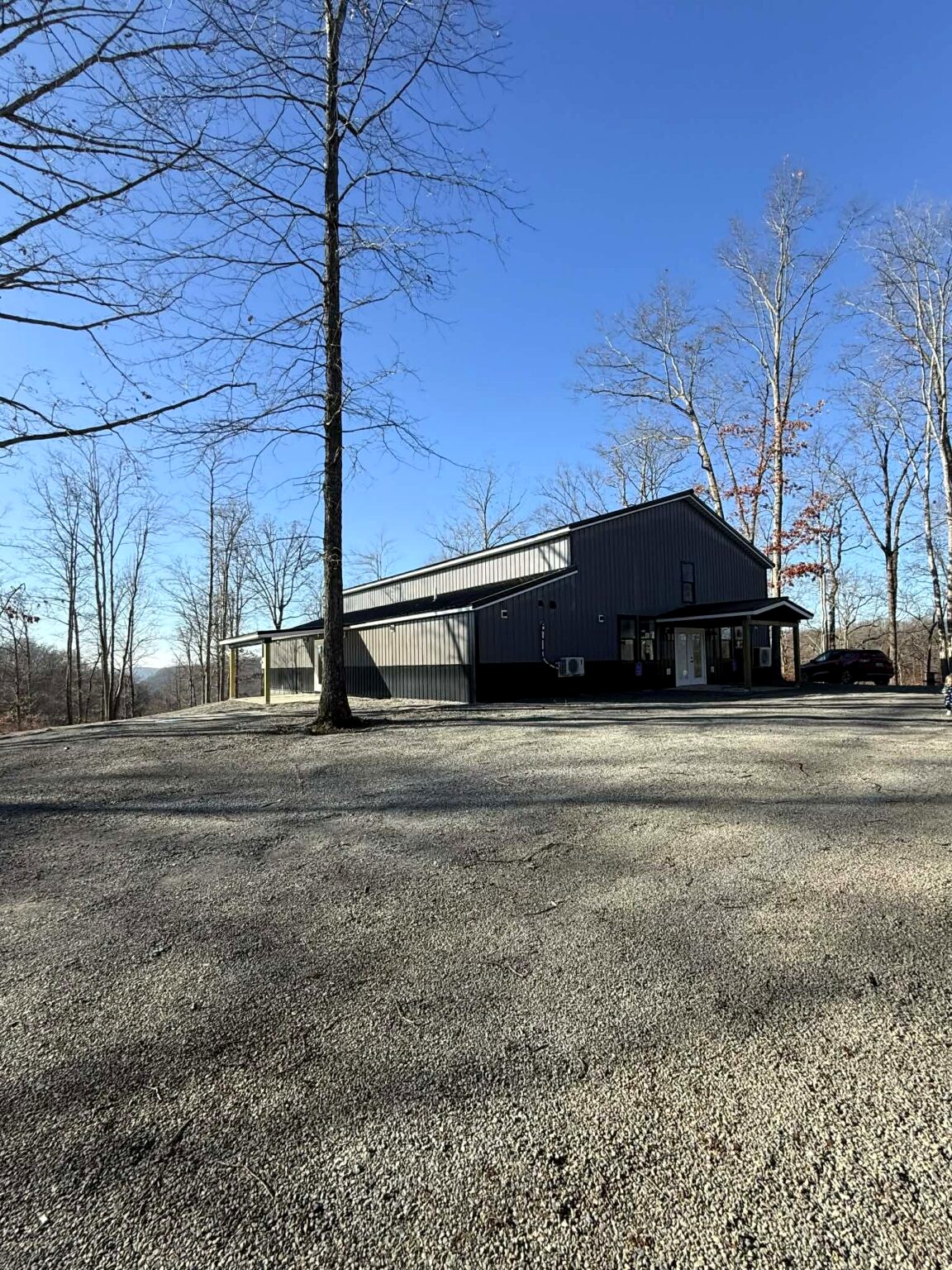 Events center building and surrounding woods